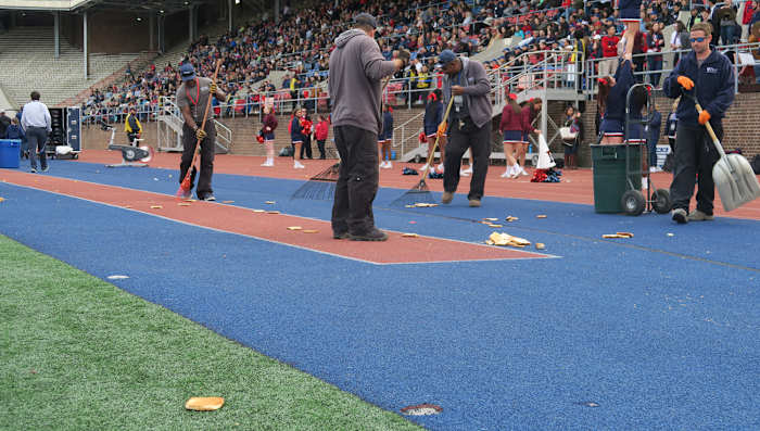 A crew cleans up after the traditional “toast” between the third and fourth quarter.